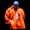 Kendrick Lamar Wearing Red Oversized Jacket And Blue Cap PNG